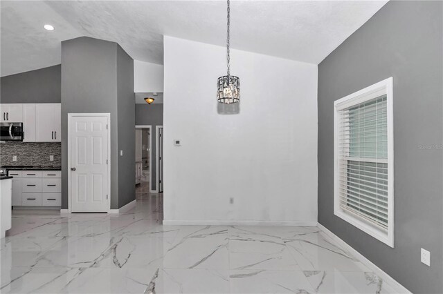 14550 SW 61st Ct, Ocala, FL 34473 - unfurnished dining area featuring baseboards, a chandelier, light marble finish floors, vaulted ceiling, and recessed lighting
