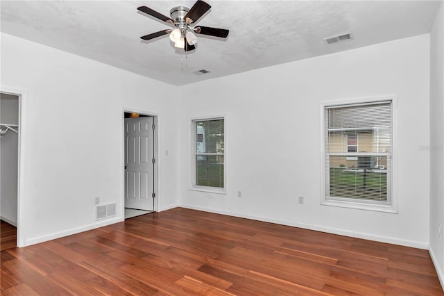 14550 SW 61st Ct, Ocala, FL 34473 - unfurnished bedroom featuring wood finished floors, baseboards, and a ceiling fan