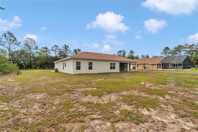 14550 SW 61st Ct, Ocala, FL 34473 - back of house featuring a yard, stucco siding, and central AC unit