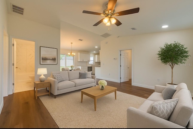 3529 SW 150th Ct, Dunnellon, FL 34432 - living room with dark wood-style floors, a ceiling fan, a chandelier, recessed lighting, and baseboards