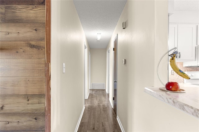 5005 NE 22nd Ave, Ocala, FL 34479 - hall featuring a textured ceiling, baseboards, and dark wood-style floors