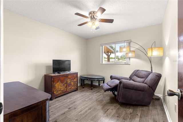5005 NE 22nd Ave, Ocala, FL 34479 - sitting room with ceiling fan, light wood-style flooring, baseboards, and a textured ceiling