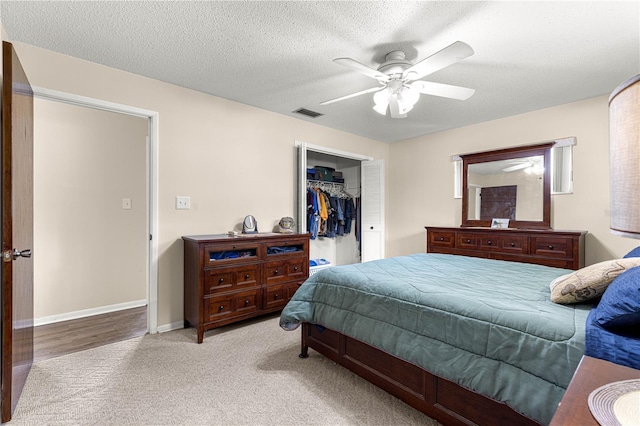 5005 NE 22nd Ave, Ocala, FL 34479 - carpeted bedroom featuring a closet, ceiling fan, baseboards, and a textured ceiling