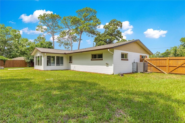 5005 NE 22nd Ave, Ocala, FL 34479 - rear view of house featuring central AC unit and a gate