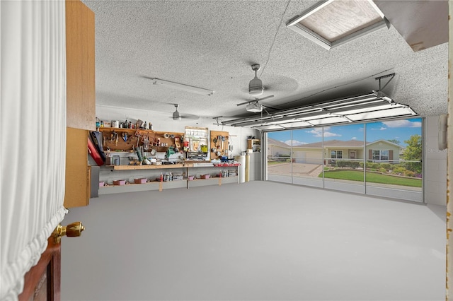 5005 NE 22nd Ave, Ocala, FL 34479 - garage with a garage door opener, a workshop area, and ceiling fan