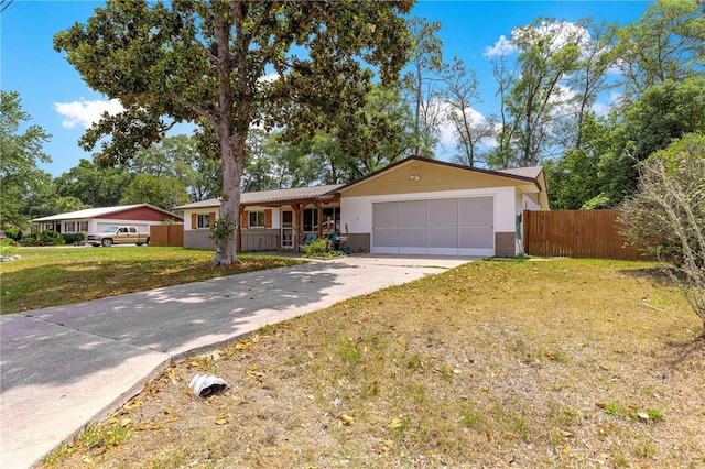 5005 NE 22nd Ave, Ocala, FL 34479 - ranch-style house with an attached garage, concrete driveway, and a porch