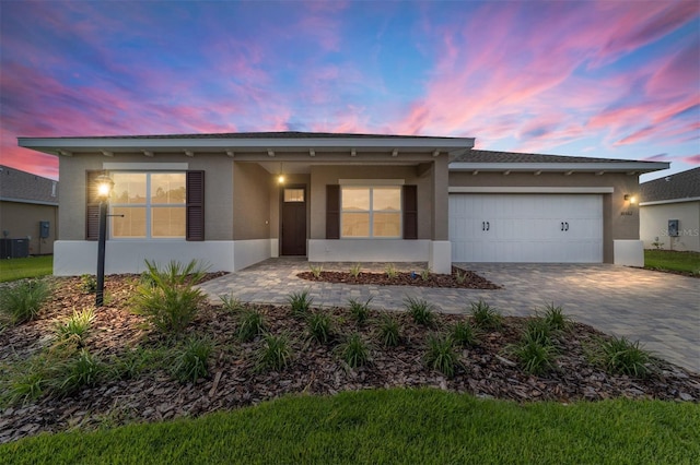 10562 SW 96th Lane Rd, Ocala, FL 34481 - ranch-style home with stucco siding, decorative driveway, and a garage