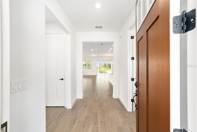 10562 SW 96th Lane Rd, Ocala, FL 34481 - hallway with recessed lighting, light wood finished floors, and baseboards