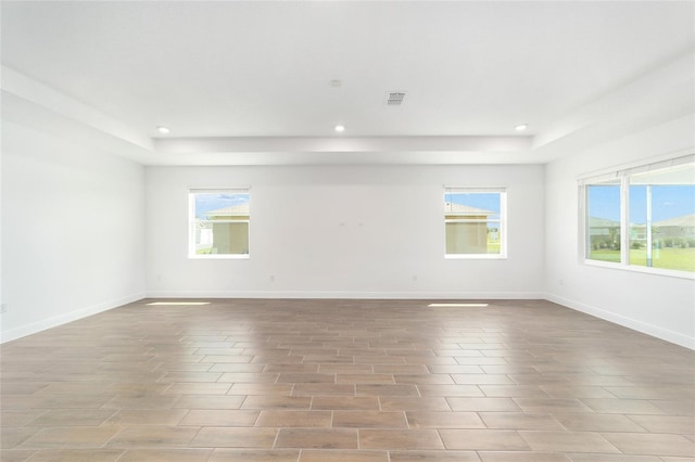 10562 SW 96th Lane Rd, Ocala, FL 34481 - spare room with a tray ceiling, recessed lighting, baseboards, and wood finished floors