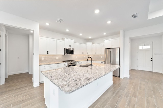 10562 SW 96th Lane Rd, Ocala, FL 34481 - kitchen with appliances with stainless steel finishes, a sink, tasteful backsplash, white cabinets, and recessed lighting