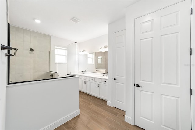 10562 SW 96th Lane Rd, Ocala, FL 34481 - full bath featuring double vanity, walk in shower, and wood tiled floors