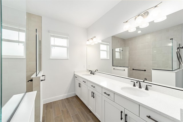 10562 SW 96th Lane Rd, Ocala, FL 34481 - full bath featuring double vanity, healthy amount of natural light, a walk in shower, and baseboards