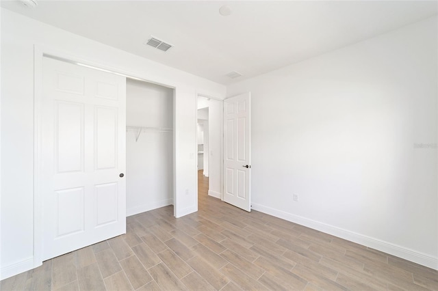 10562 SW 96th Lane Rd, Ocala, FL 34481 - unfurnished bedroom with light wood-style floors, baseboards, and a closet