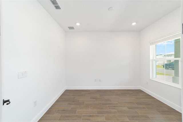 10562 SW 96th Lane Rd, Ocala, FL 34481 - spare room with wood finished floors, baseboards, and recessed lighting
