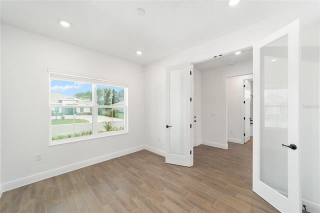 10562 SW 96th Lane Rd, Ocala, FL 34481 - unfurnished room with wood finished floors, recessed lighting, and baseboards