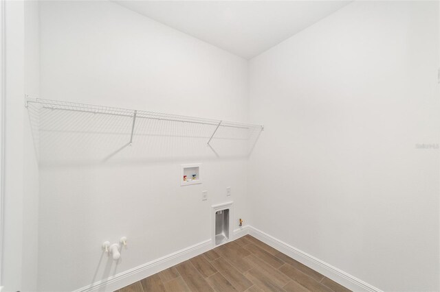 10562 SW 96th Lane Rd, Ocala, FL 34481 - laundry room with hookup for a gas dryer, baseboards, hookup for a washing machine, and wood finished floors