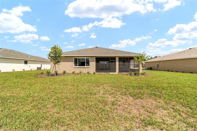 10562 SW 96th Lane Rd, Ocala, FL 34481 - back of house featuring a sunroom, a yard, and stucco siding