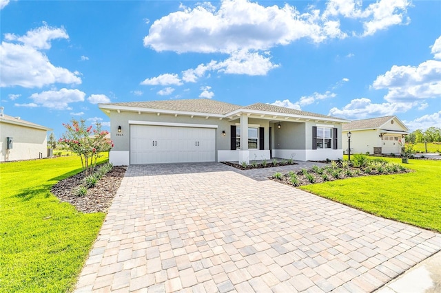 9865 SW 105th Ct, Ocala, FL 34481 - ranch-style house with decorative driveway, a front yard, stucco siding, and an attached garage