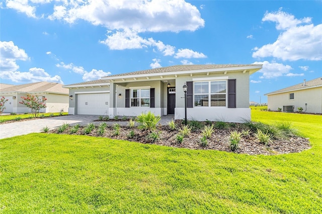 9865 SW 105th Ct, Ocala, FL 34481 - single story home with a front yard, decorative driveway, stucco siding, and a garage