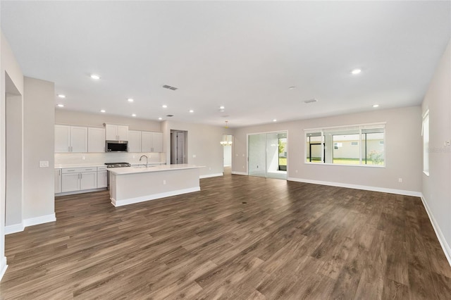 9865 SW 105th Ct, Ocala, FL 34481 - unfurnished living room with a sink, recessed lighting, wood finished floors, and baseboards