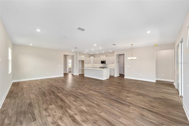 9865 SW 105th Ct, Ocala, FL 34481 - unfurnished living room with a chandelier, wood finished floors, baseboards, and recessed lighting