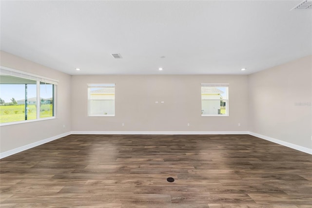 9865 SW 105th Ct, Ocala, FL 34481 - empty room with healthy amount of natural light, baseboards, recessed lighting, and wood finished floors