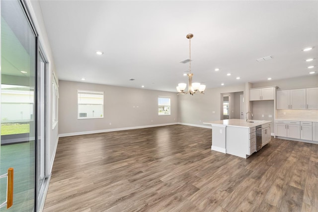 9865 SW 105th Ct, Ocala, FL 34481 - kitchen with open floor plan, a chandelier, white cabinets, light countertops, and light wood-style flooring