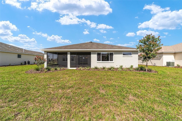 9865 SW 105th Ct, Ocala, FL 34481 - back of house featuring a sunroom, a yard, central AC, and stucco siding