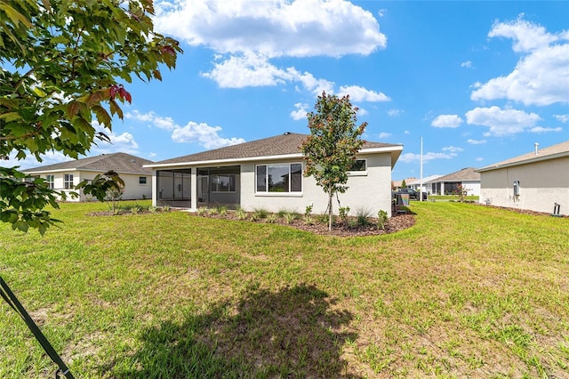 9865 SW 105th Ct, Ocala, FL 34481 - rear view of house featuring a sunroom, a lawn, and stucco siding