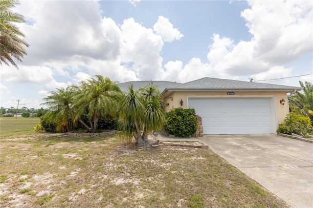 3019 NW Juanita Pl, Cape Coral, FL 33993 - view of front of home with stucco siding, driveway, a garage, and a front yard