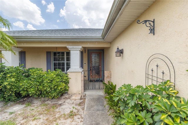 3019 NW Juanita Pl, Cape Coral, FL 33993 - entrance to property featuring stucco siding, a gate, and roof with shingles