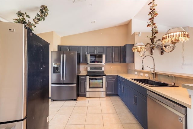 3019 NW Juanita Pl, Cape Coral, FL 33993 - kitchen featuring appliances with stainless steel finishes, a sink, vaulted ceiling, light tile patterned floors, and a chandelier