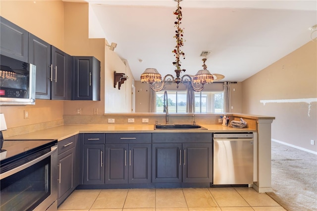 3019 NW Juanita Pl, Cape Coral, FL 33993 - kitchen featuring stainless steel appliances, a chandelier, light countertops, a peninsula, and a sink