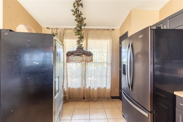 3019 NW Juanita Pl, Cape Coral, FL 33993 - kitchen featuring stainless steel refrigerator with ice dispenser, freestanding refrigerator, and light tile patterned floors