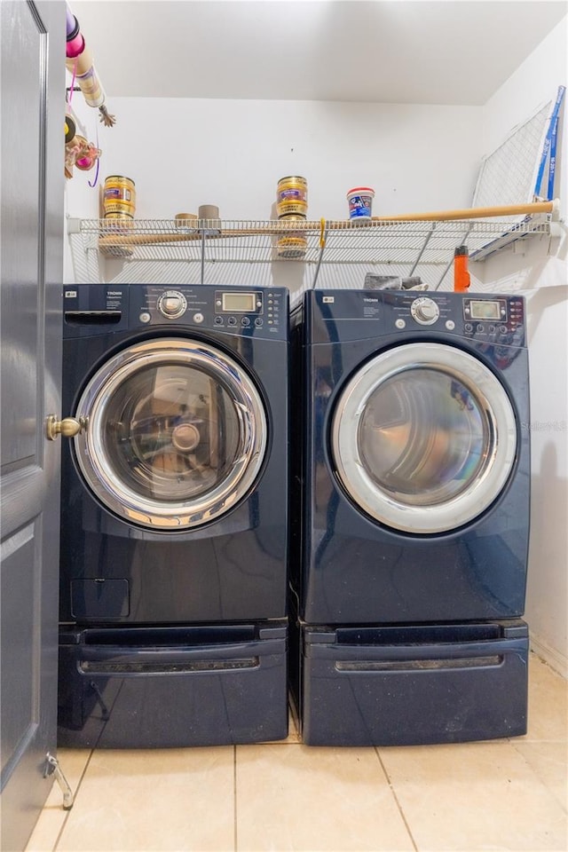 3019 NW Juanita Pl, Cape Coral, FL 33993 - washroom featuring tile patterned floors and washing machine and clothes dryer