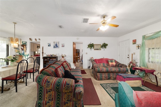 17128 SE 140th Ave, Weirsdale, FL 32195 - living room featuring a ceiling fan, light colored carpet, and a chandelier