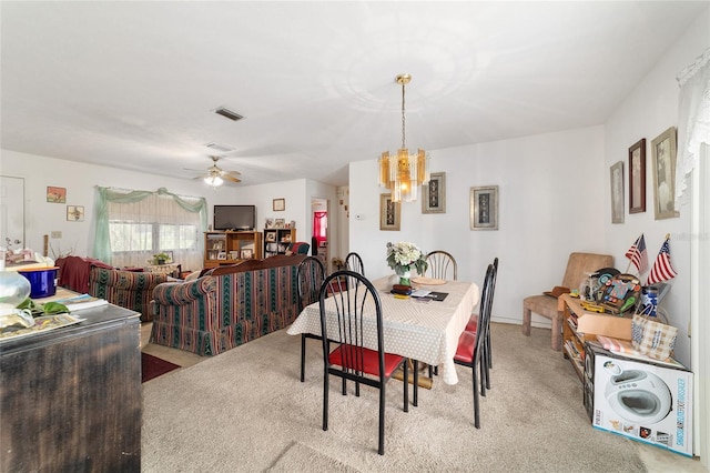17128 SE 140th Ave, Weirsdale, FL 32195 - dining area featuring light colored carpet, a chandelier, and ceiling fan