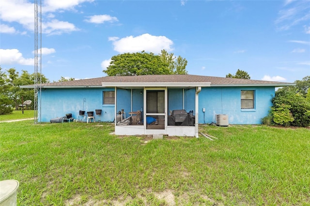 17128 SE 140th Ave, Weirsdale, FL 32195 - rear view of property with a sunroom, a lawn, and stucco siding