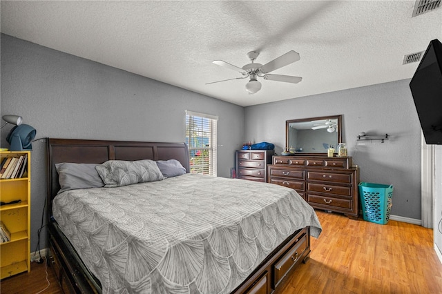 9 Bahia Trace Loop, Ocala, FL 34472 - bedroom featuring light wood-style flooring, baseboards, a textured ceiling, and a ceiling fan