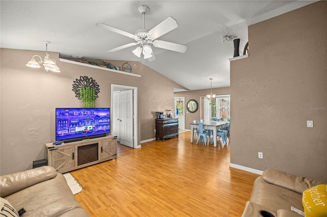 9 Bahia Trace Loop, Ocala, FL 34472 - living area with a chandelier, a textured wall, light wood-style floors, lofted ceiling, and a ceiling fan
