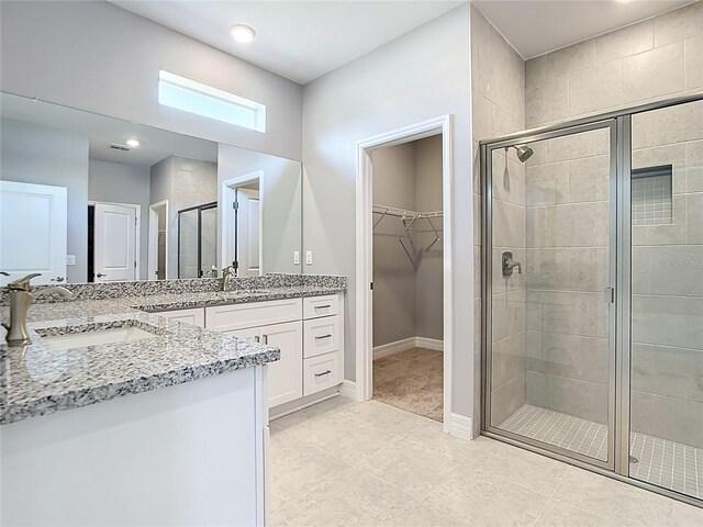 3018 Oceanside St, North Port, FL 34286 - full bath featuring vanity, a shower stall, a walk in closet, tile patterned floors, and baseboards