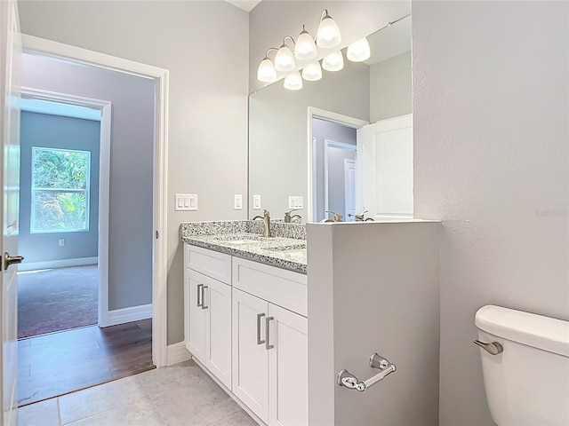 3018 Oceanside St, North Port, FL 34286 - bathroom with toilet, double vanity, and tile patterned floors