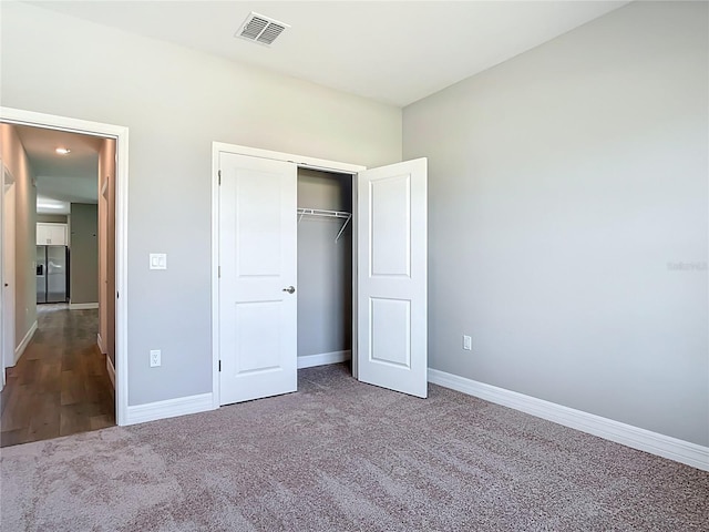 3018 Oceanside St, North Port, FL 34286 - unfurnished bedroom with stainless steel fridge with ice dispenser, baseboards, carpet floors, and a closet