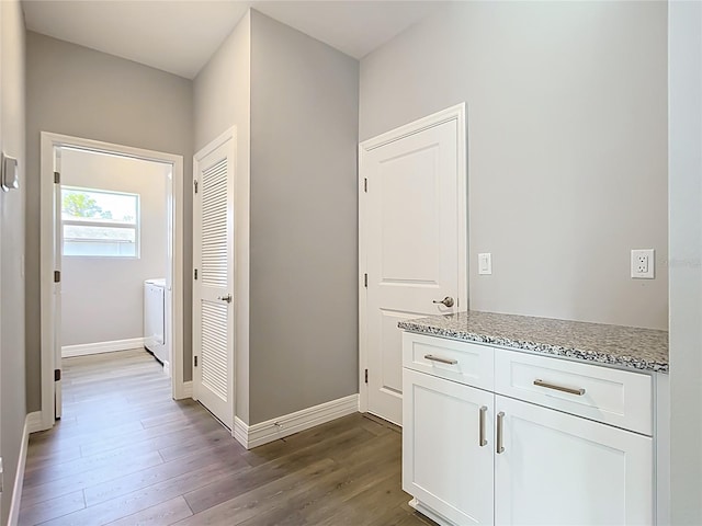 3018 Oceanside St, North Port, FL 34286 - hallway featuring dark wood-style floors, washer / clothes dryer, and baseboards