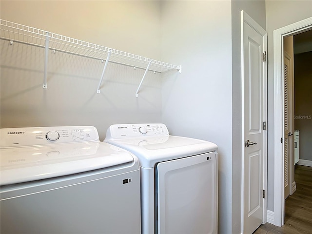 3018 Oceanside St, North Port, FL 34286 - washroom featuring washer and dryer, wood finished floors, and baseboards