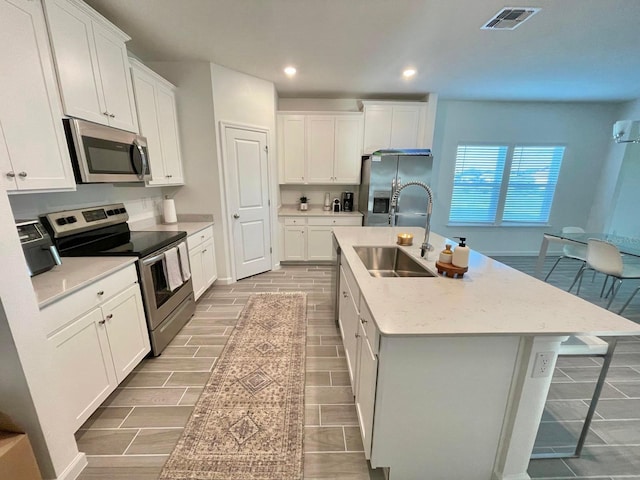 9253 SW 58th Cir, Ocala, FL 34476 - kitchen with appliances with stainless steel finishes, a sink, an island with sink, recessed lighting, and white cabinetry