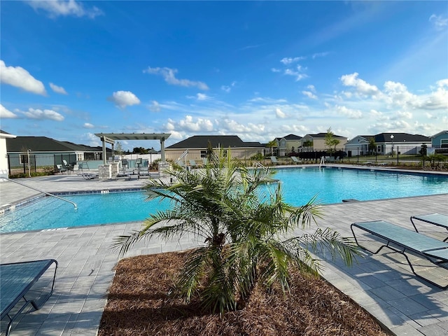 9253 SW 58th Cir, Ocala, FL 34476 - community pool with a pergola, a patio, and a residential view