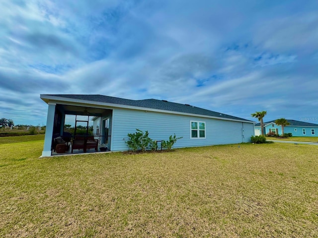 9253 SW 58th Cir, Ocala, FL 34476 - view of side of home featuring a sunroom, ceiling fan, and a lawn