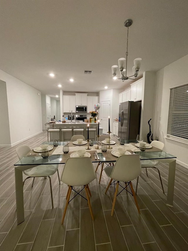 9253 SW 58th Cir, Ocala, FL 34476 - dining area with wood finish floors, a chandelier, baseboards, and recessed lighting