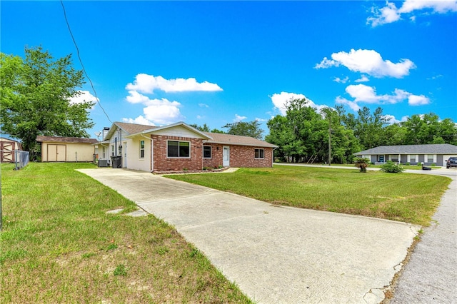 6989 SE 52nd Pl, Ocala, FL 34472 - ranch-style house featuring brick siding, driveway, a front yard, and central AC